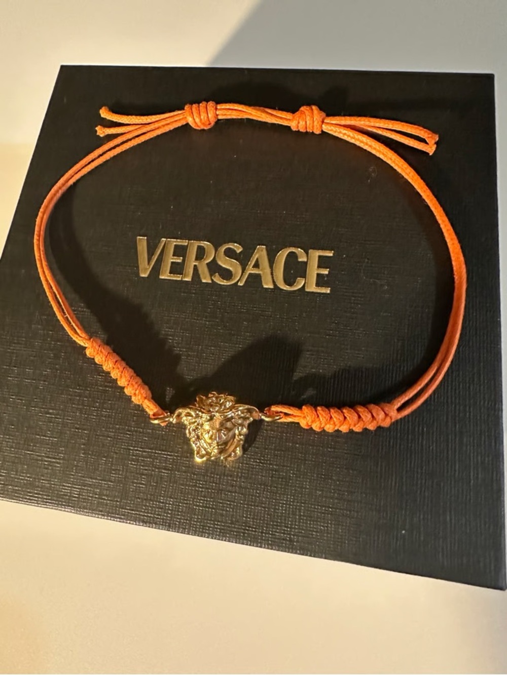 Versace Gold Medusa Charm Orange Cord Bracelet